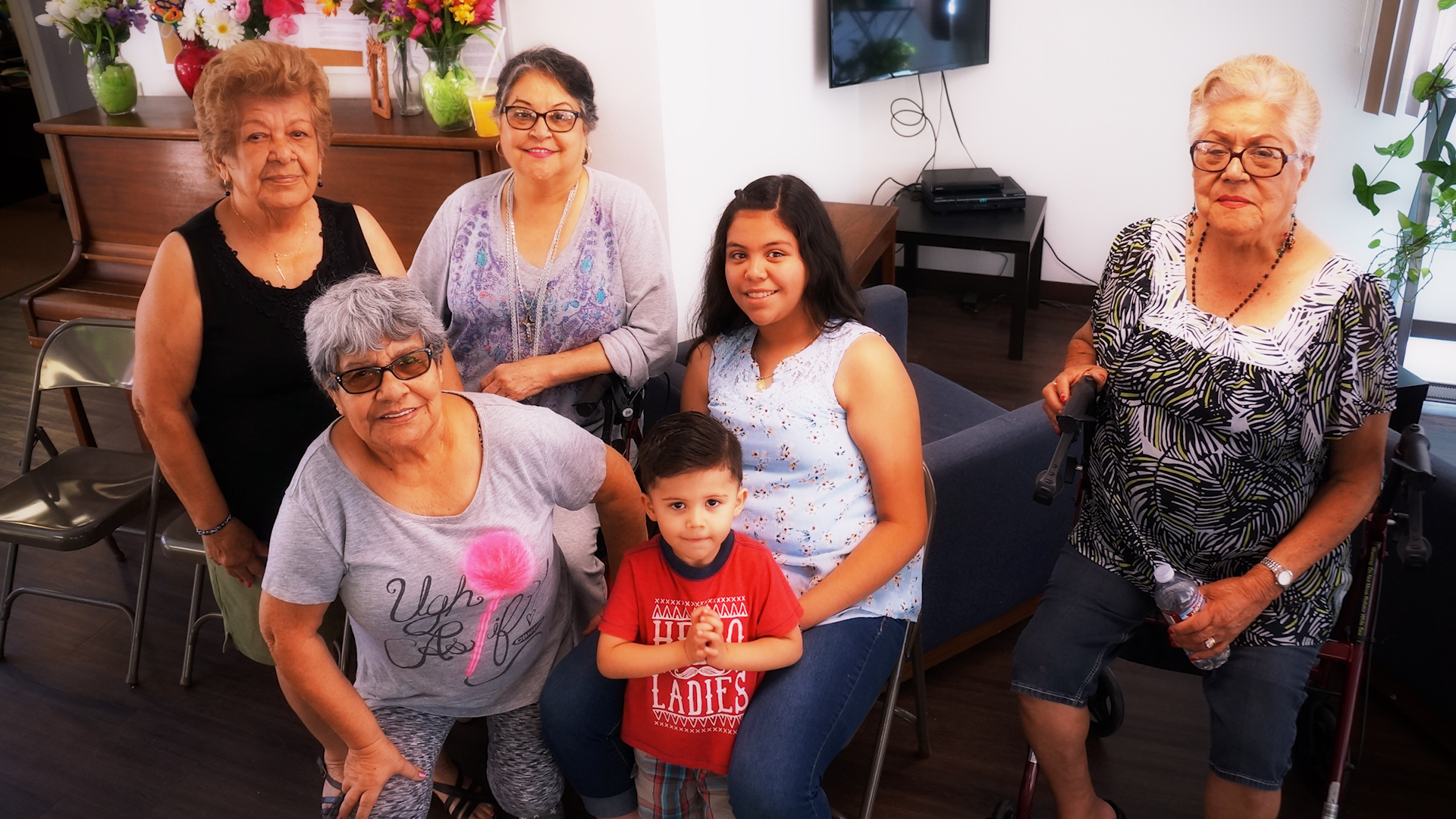A photo of a few Cambridge Gardens senior housing community residents with their children and grandchildren, symbolizing the positives of supportive housing provided by Volunteers of America Southwest.
