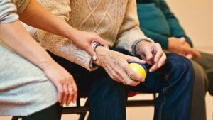 elderly person holding a stress ball